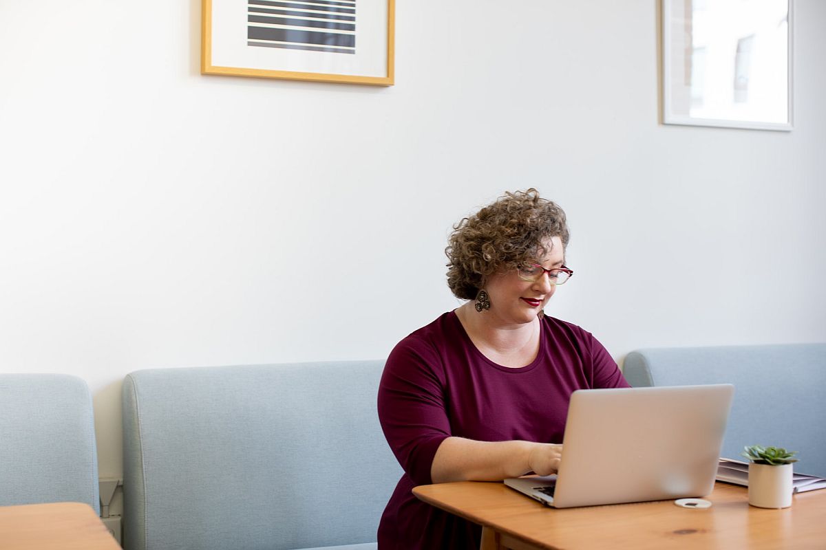 Woman working on laptop; tailor rewards concept