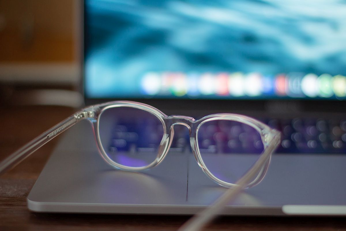 A pair of glasses in front of a computer monitor; pay transparency concept