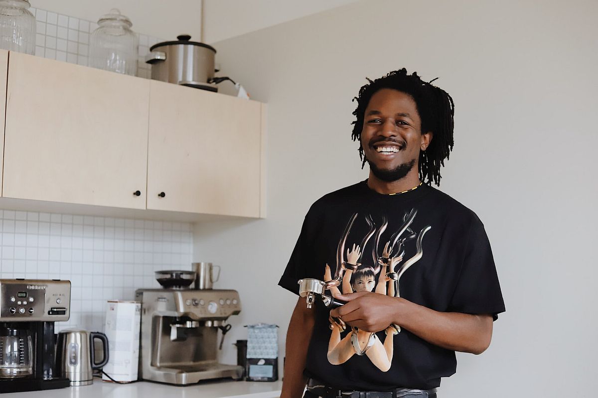 Smiling man making coffee; employee recognition concept