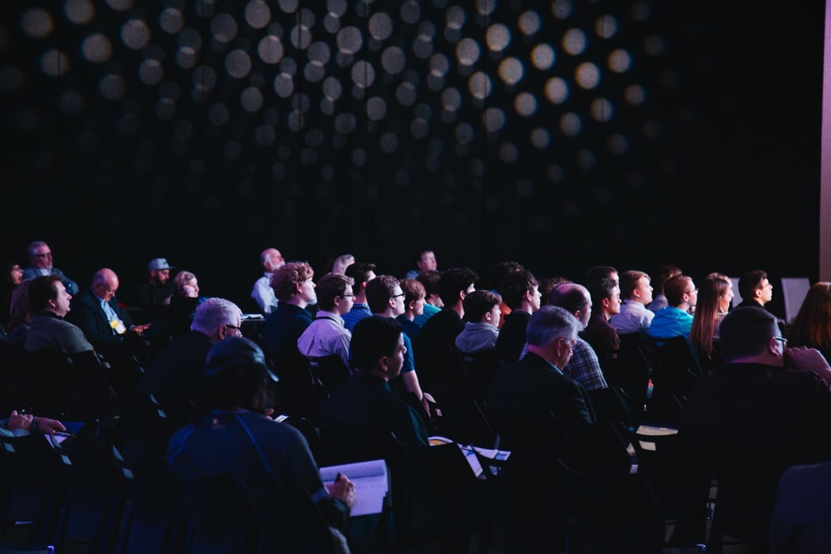 dark room in a full conference hall; hr technology conference concept