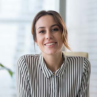 Woman smiling at camera inside office