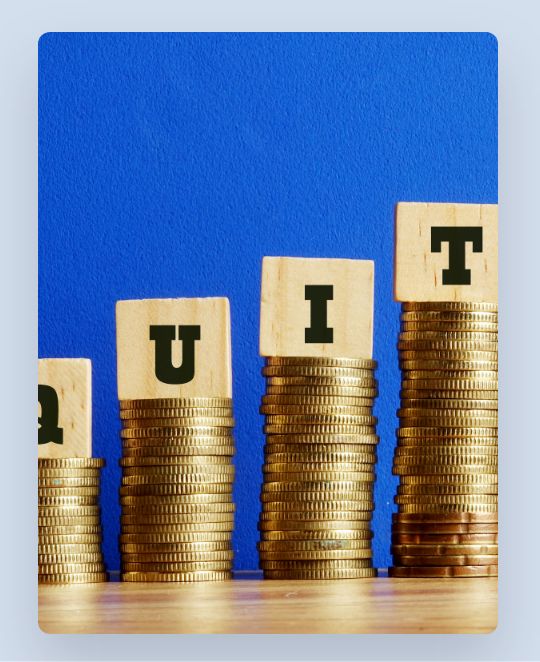 Wooden blocks with black letters on coins stacks of different heights