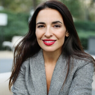 Dark-haired woman smiling at camera