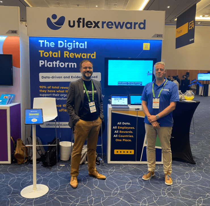 Jonathan Best and Rob Douglas standing in front of uFlexReward booth